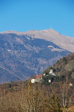 Santa Augusta's castle towering over the old district of Serravalle, Vittorio Veneto. In the background the highest mountain of the Treviso's province, Col Visentin.のeditorial素材
