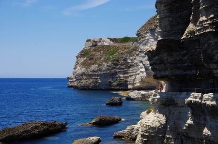 BONIFACIO,FR - JUNE 21, 2017 - Tourists on the narrow path carved in the cliffs below Bonifacioのeditorial素材