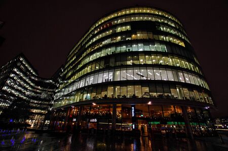 LONDON,UK - CIRCA OCT 2017 - Night view of offices and restaurants on the riverside near the city hall.のeditorial素材