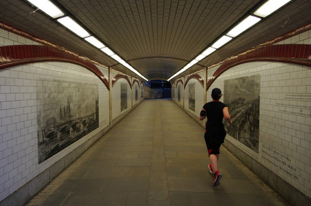 LONDON,UK - CIRCA OCT 2017 - Woman run along the Thames path, under the Blackfriars bridge. のeditorial素材