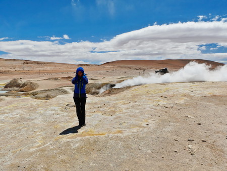 Andean altiplano of Bolivia, South America. Siloli desert is a plateau at 4500m on the sea level. Young female european touristの写真素材