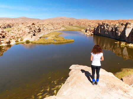 Young tourist at Laguna Escondida and rock formations. Andean altiplano of Bolivia, South Americaのeditorial素材