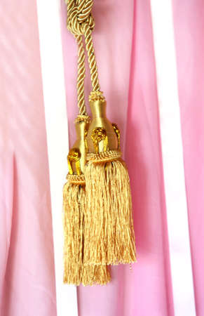 Close up gold color elegance curtain tassel in luxury house の写真素材