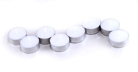 Several tea light candles on a white background  の写真素材