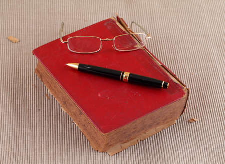 Old book with Eye glass and penの写真素材