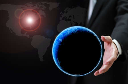 Holding a glowing earth globe in his hands  の写真素材