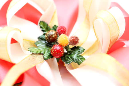 Shiny red and gold ribbon bow on white background の写真素材