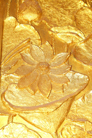 Detail of golden embossed doors in a Buddhist temple の写真素材