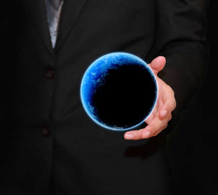 holding a glowing earth globe in his handsの写真素材