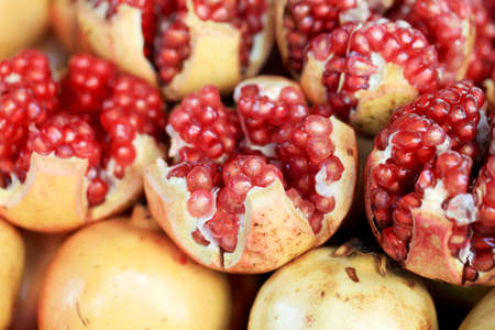 a pomegranate fruit cut in half and arils