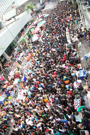 BANGKOK - APRIL 13  Stream of water over the crowd of people during celebrating the traditional Songkran New Year Festival, April 13, 2012, Silom road, Bangkok, Thailand のeditorial素材
