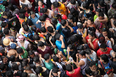 BANGKOK - APRIL 13  Stream of water over the crowd of people during celebrating the traditional Songkran New Year Festival, April 13, 2012, Silom road, Bangkok, Thailand のeditorial素材