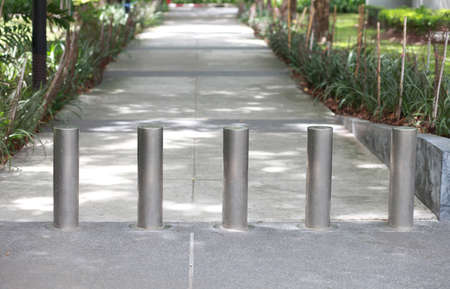 Steel barrier on the sidewalk in the park 