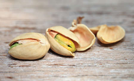 Pistachio nuts on wood background