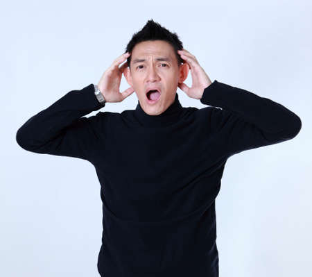 amazed man portrait isolated on gray background.の写真素材