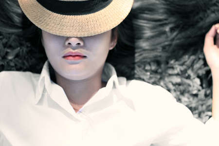 young asian woman relaxing on the grassの写真素材