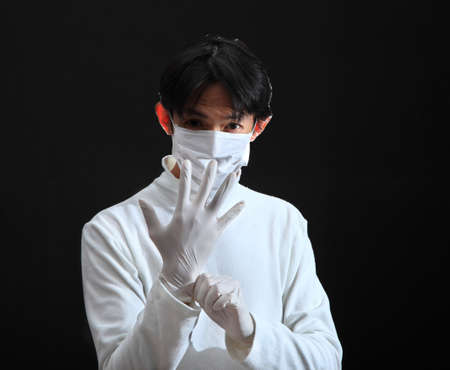 Doctor putting on a latex glove.の写真素材