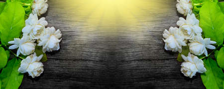 Tropical jasmine flower on wood.Jasmine flowers and leaves on brown wooden board.の写真素材