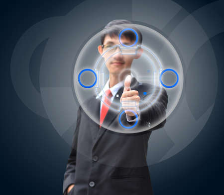 Young business man in a suit pointing with his fingerの写真素材