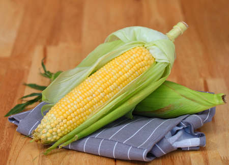 fresh corn on wooden table