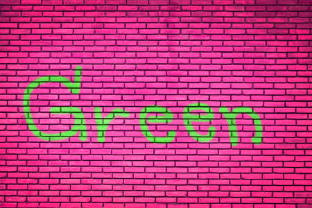 Green text on brick wall pink Backgroundの写真素材