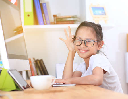 Girls wearing glasses using Computer,and smiling.