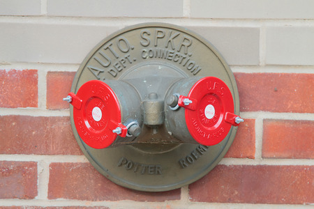 American brass standpipe with two red caps. New York. USA.
