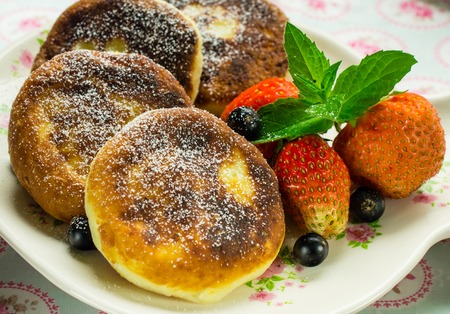 Delicious dessert. pancakes with strawberries and currants.の写真素材