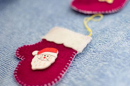 Red mittens with Santa Claus on a blue backgroundの写真素材