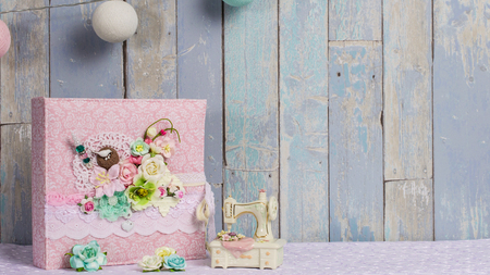 a photo album in the style of shabby chic on a blue backgroundの写真素材