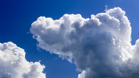 a big and fluffy cumulonimbus cloud in the blue sky.の写真素材