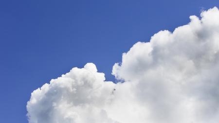 a big and fluffy cumulonimbus cloud in the blue sky.の写真素材
