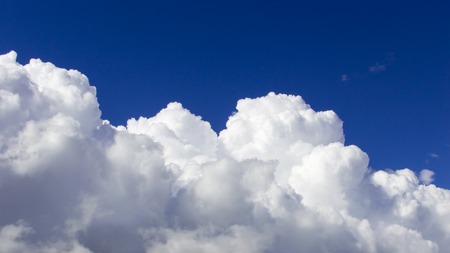 A big and fluffy cumulonimbus cloud in the blue sky.の写真素材