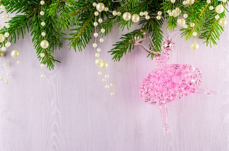 Christmas card of fir branches and pink ballerina on a grey backgroundの写真素材