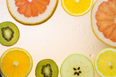 orange grapefruit  and kiwi slices on white background