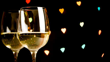 wine glass on hearts bokeh backgroundの写真素材