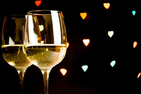 wine glass on hearts bokeh backgroundの写真素材