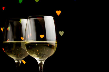 wine glass on hearts bokeh backgroundの写真素材
