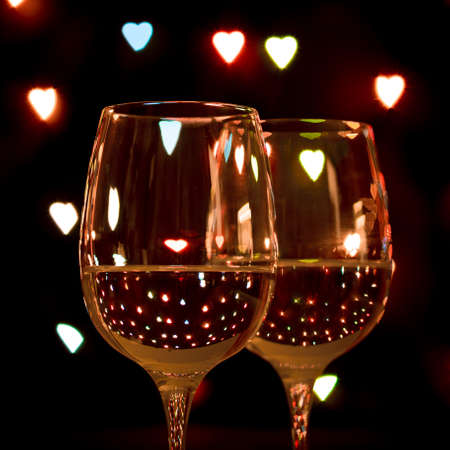 wine glass on hearts bokeh backgroundの写真素材