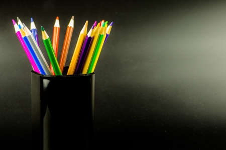 colored pencils on black backgroundの写真素材