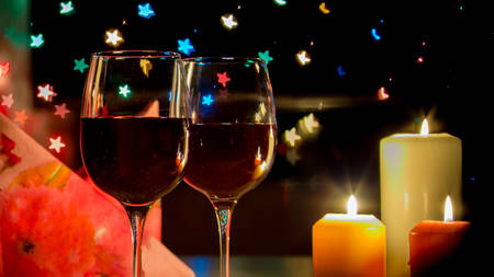 wine glass on hearts bokeh backgroundの写真素材