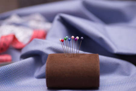 pincushion with pins on blue backgroundの写真素材