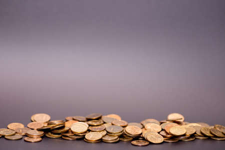 a scattering of coins on a black backgroundの写真素材