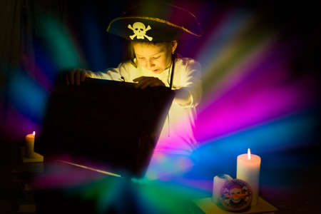 Childhood dreams. Adventurous girl found a treasures. Happy young pirate.の写真素材