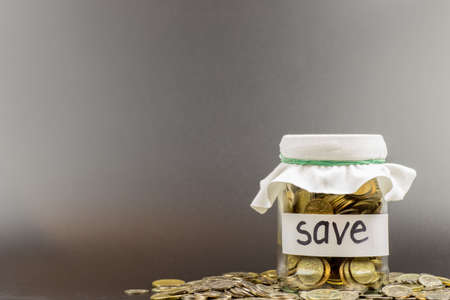 glass jar with coins and the inscription save. business conceptの写真素材