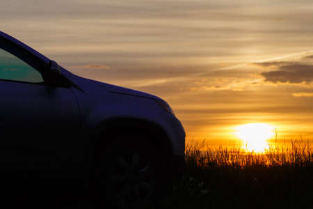 the silhouette of the car at sunset.の写真素材