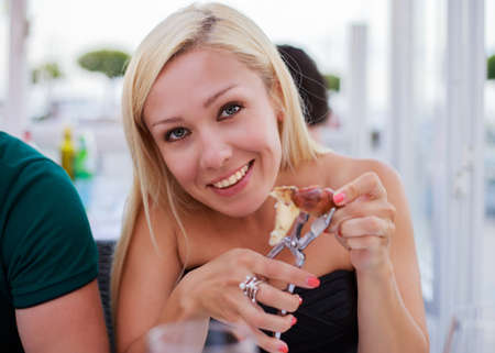 Restaurant tourists couple eating at outdoor cafe.の写真素材
