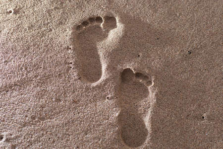 Human footprints on the sand beach. Travel vacations concept.の写真素材