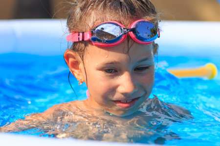 Young girl having good time in the swimming pool.の写真素材