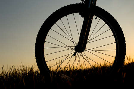 Silhouette of mountain bicycle on the sunset background.の写真素材